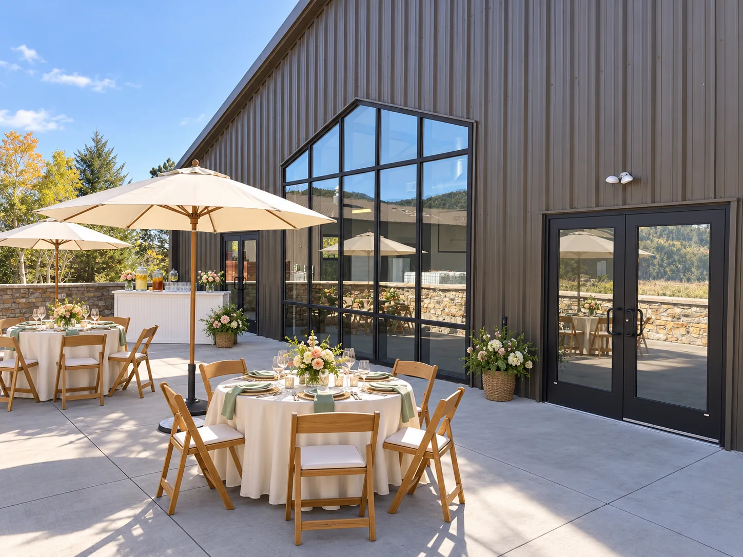 Outdoor terrace with round dining tables beside the distillery building